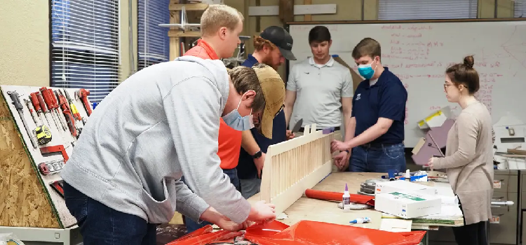 University of South Alabama mechanical engineering students work on a 82-inch-long wing that will provide stability for their remote-control cargo plane in the Design, Build, Fly competition.